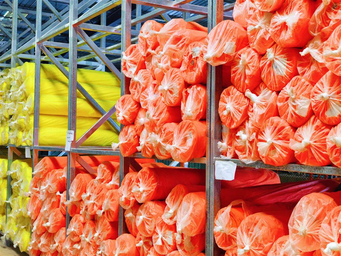High visibility fabric rolls stored on warehouse racks