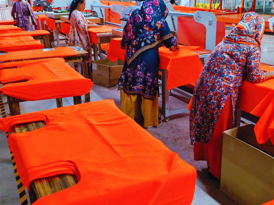 Heat-applied reflective strip work on orange safety fabric