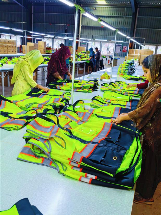 Workers inspecting finished reflective workwear